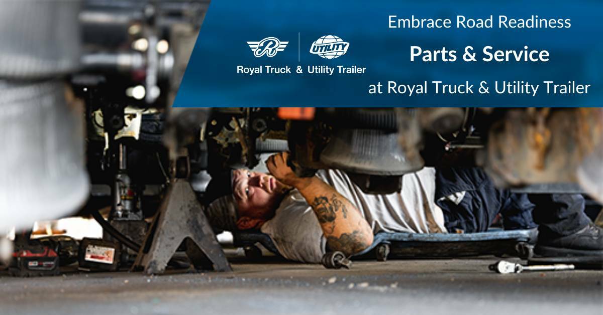 A Mechanic Laying on Back on The Floor Fixing a Semi Trailer | Embrace Road Readiness | Parts & Service at Royal Truck & Utility Trailer